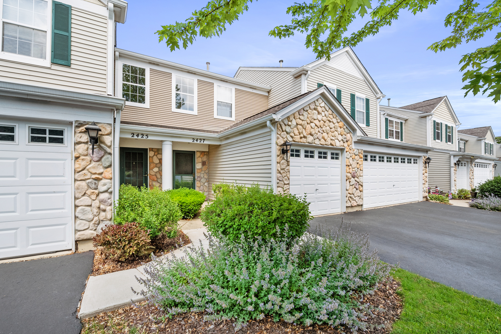 2427 Oak Tree Lane Plainfield, IL 60586 - Photo 2 of 24 front view of a house with a garden