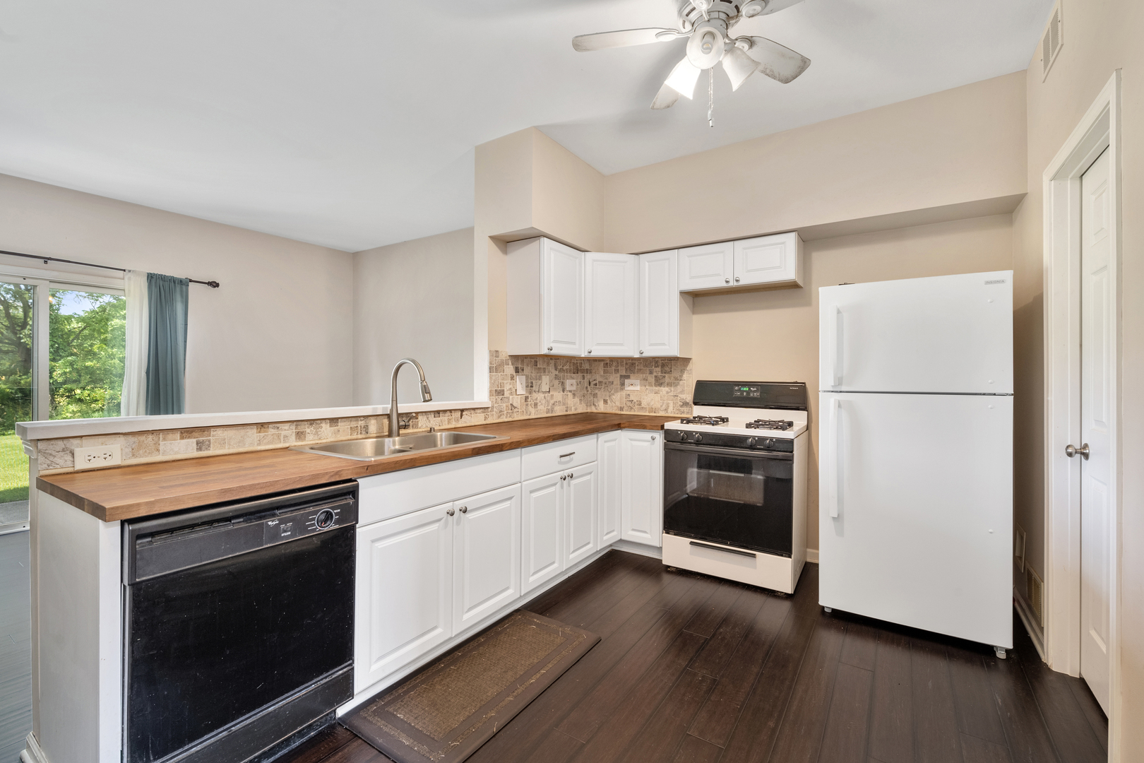 2427 Oak Tree Lane Plainfield, IL 60586 - Photo 11 of 24 a kitchen with stainless steel appliances granite countertop a stove a sink and a refrigerator