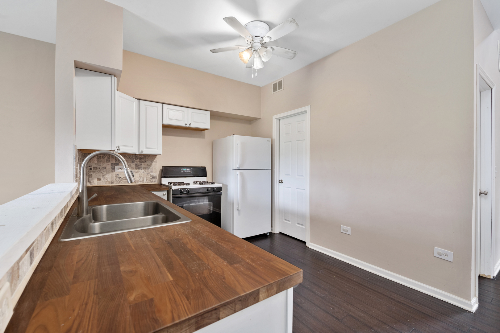 2427 Oak Tree Lane Plainfield, IL 60586 - Photo 12 of 24 a kitchen with a refrigerator sink and cabinets