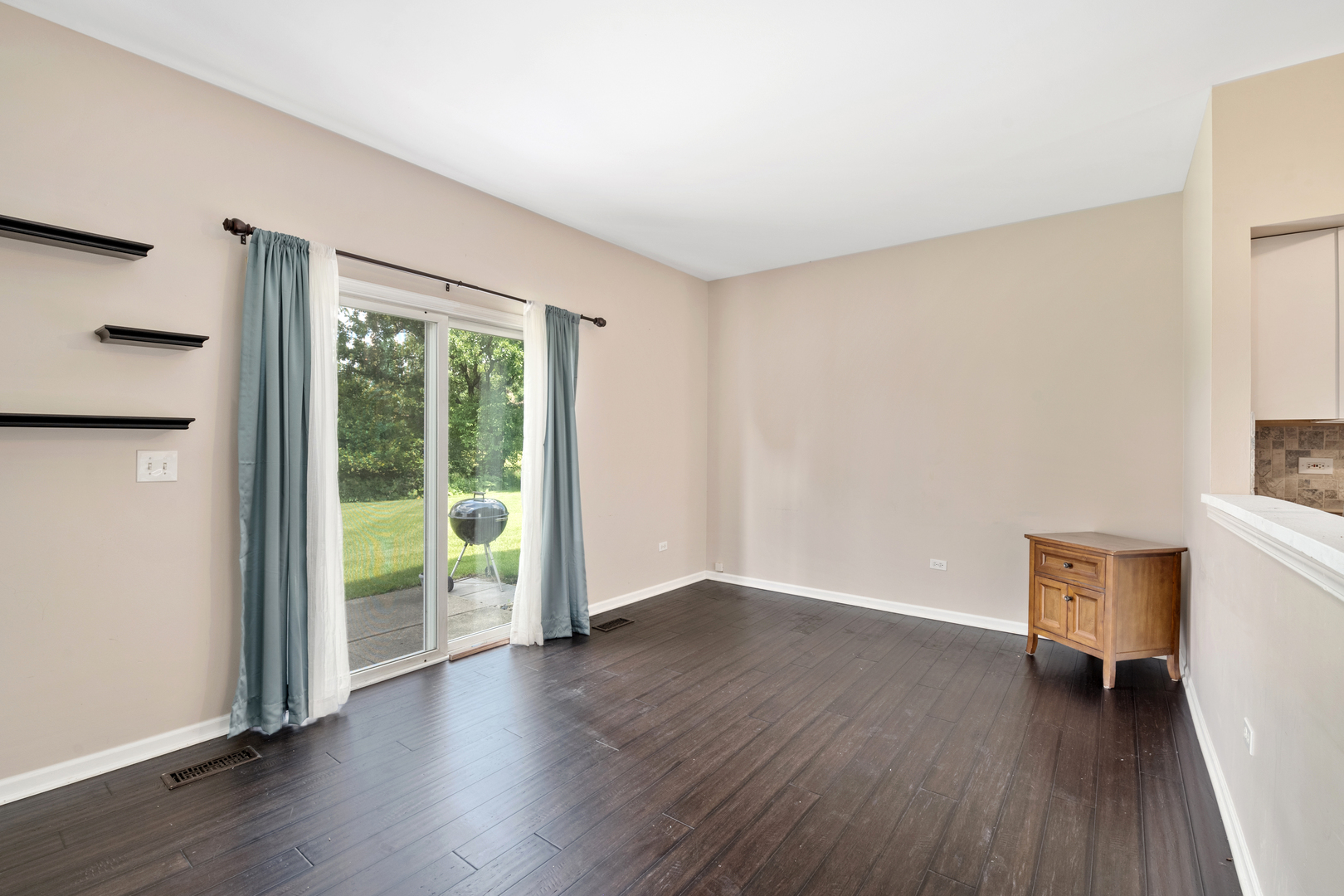 2427 Oak Tree Lane Plainfield, IL 60586 - Photo 16 of 24 a view of an empty room with wooden floor and a window