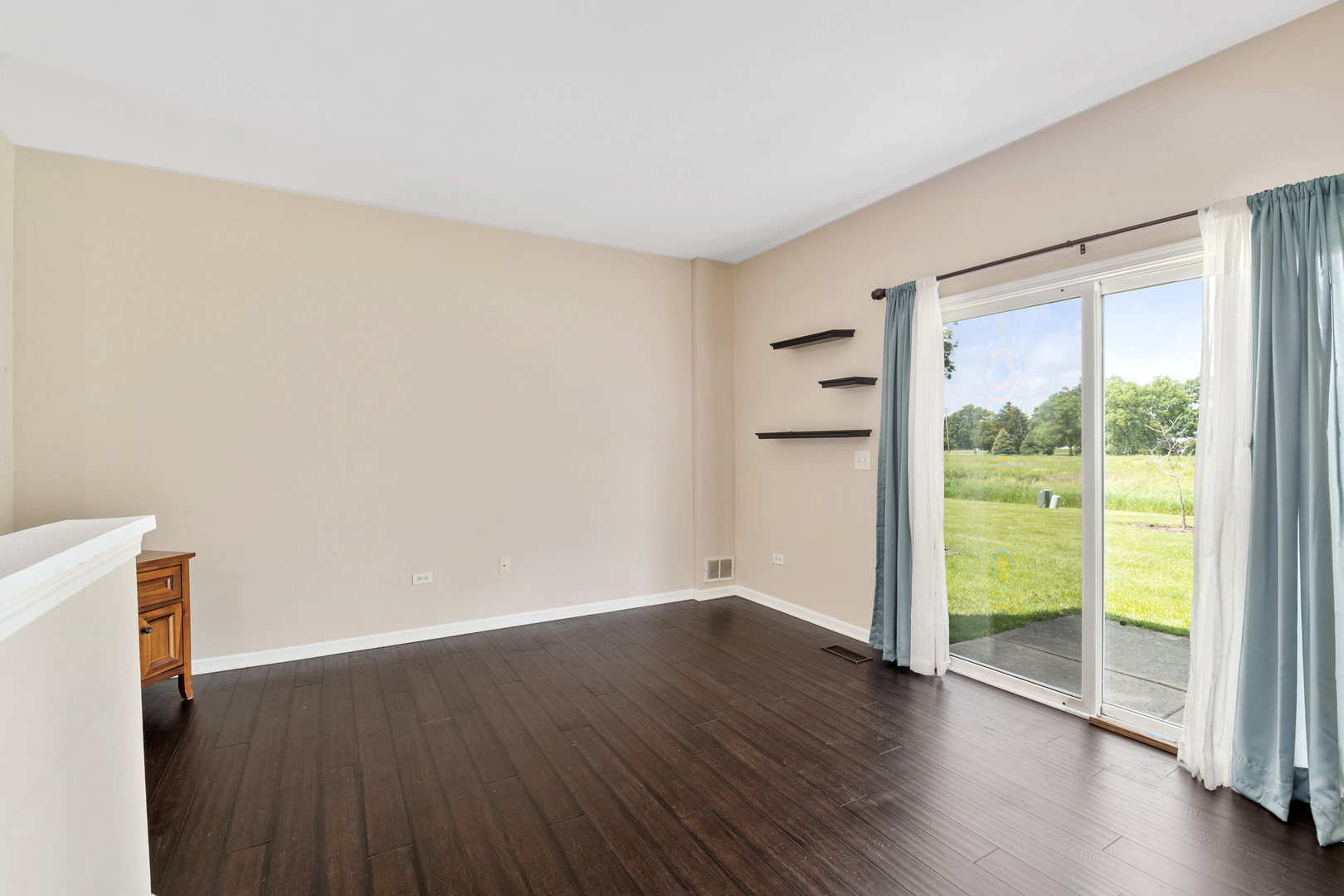 2427 Oak Tree Lane Plainfield, IL 60586 - Photo 17 of 24 a view of an empty room with wooden floor and a window