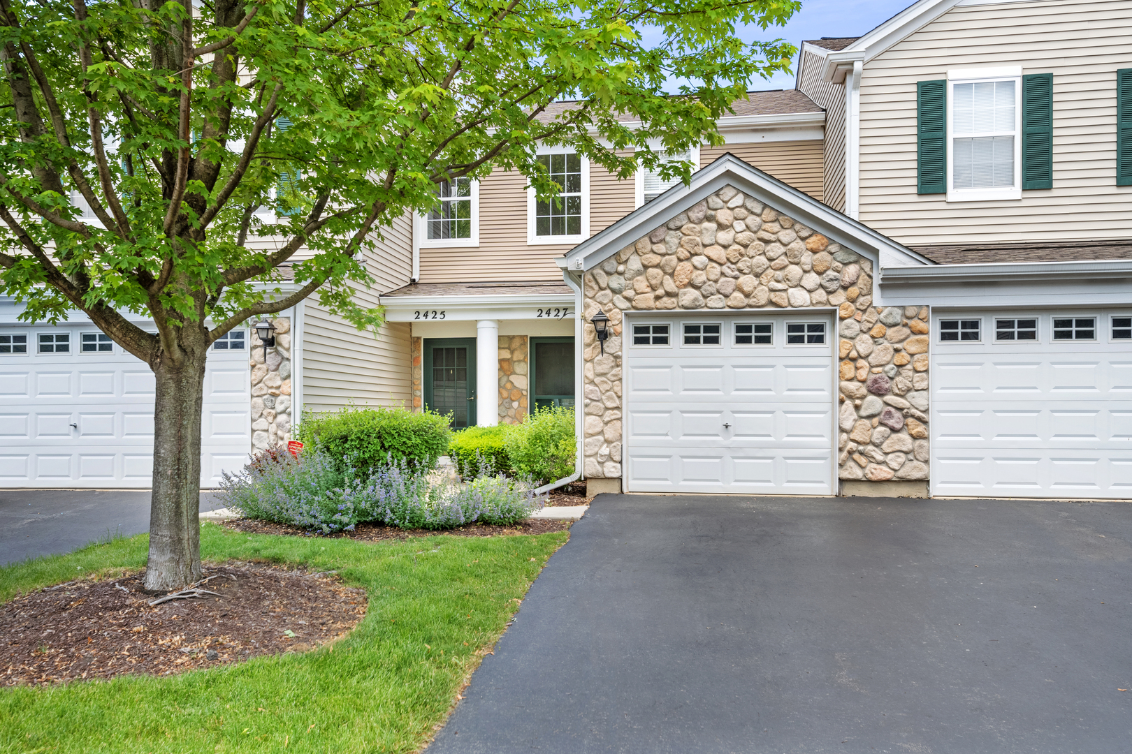 2427 Oak Tree Lane Plainfield, IL 60586 - Photo 3 of 24 a view of a house with a small yard and large tree