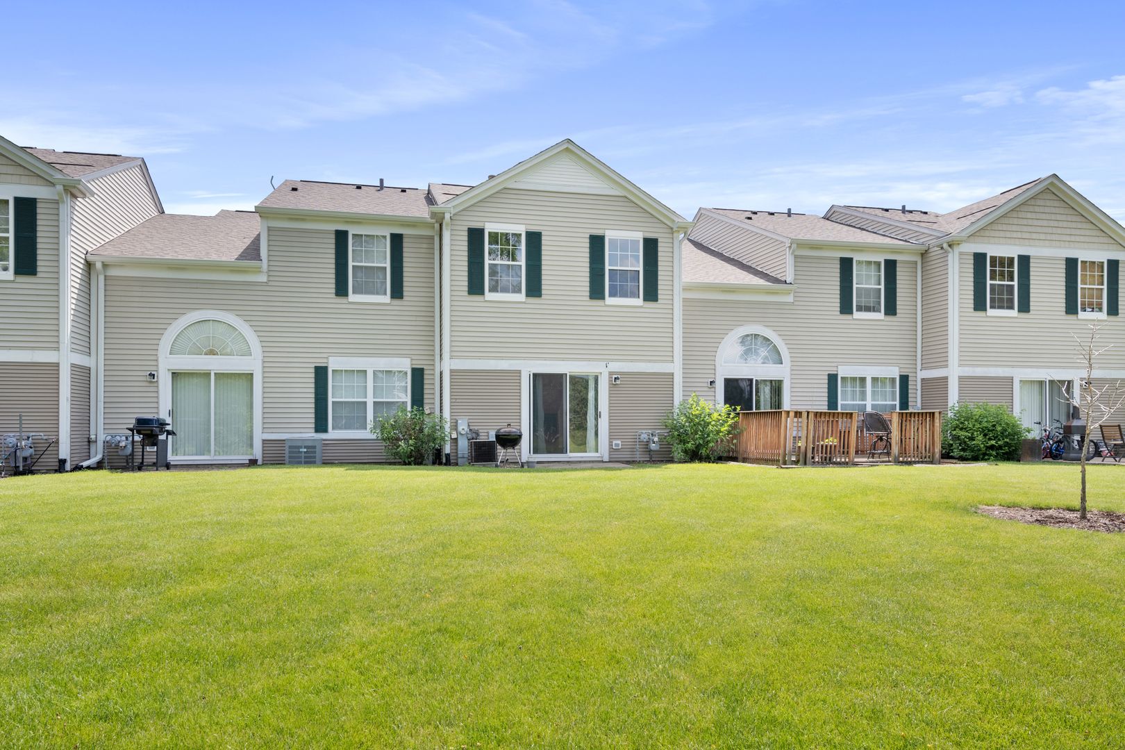 2427 Oak Tree Lane Plainfield, IL 60586 - Photo 6 of 24 a view of a white house with a big yard and large trees