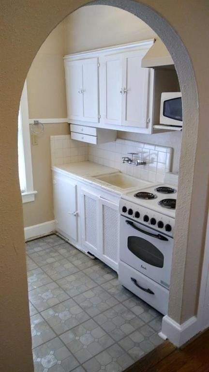 5906 Oram Street, Unit 3 Dallas, TX 75206 - Photo 9 of 10 a kitchen with stainless steel appliances a stove a microwave and a refrigerator
