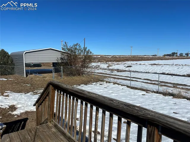 a view of a roof deck with wooden floor and fence