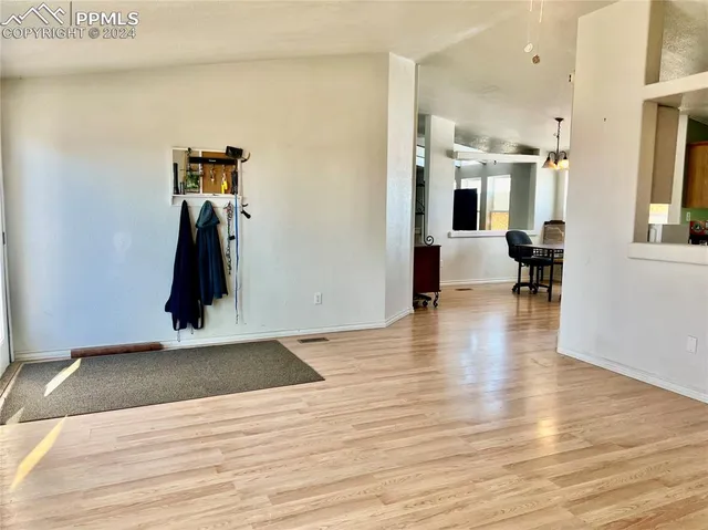 a view of a room with wooden floor and furniture