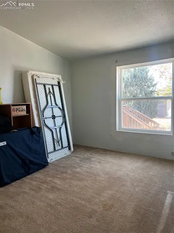 an empty room with windows and closet