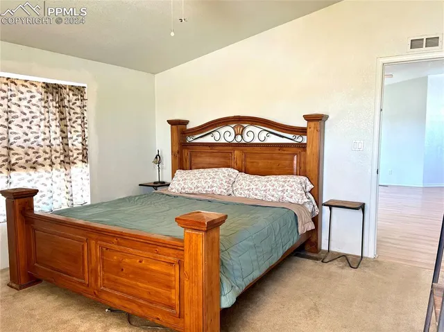 a bedroom with a bed and window