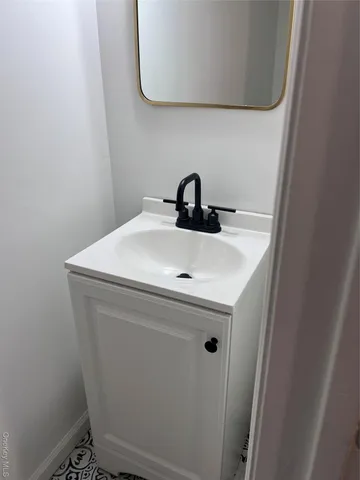 an empty room with wooden floor and a window