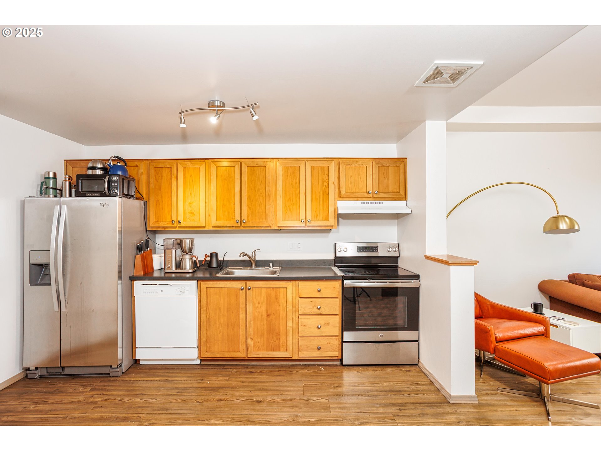 701 Columbia Street, Unit 702 Vancouver, WA 98660 - Photo 4 of 19 a kitchen with stainless steel appliances granite countertop a stove a sink and a refrigerator