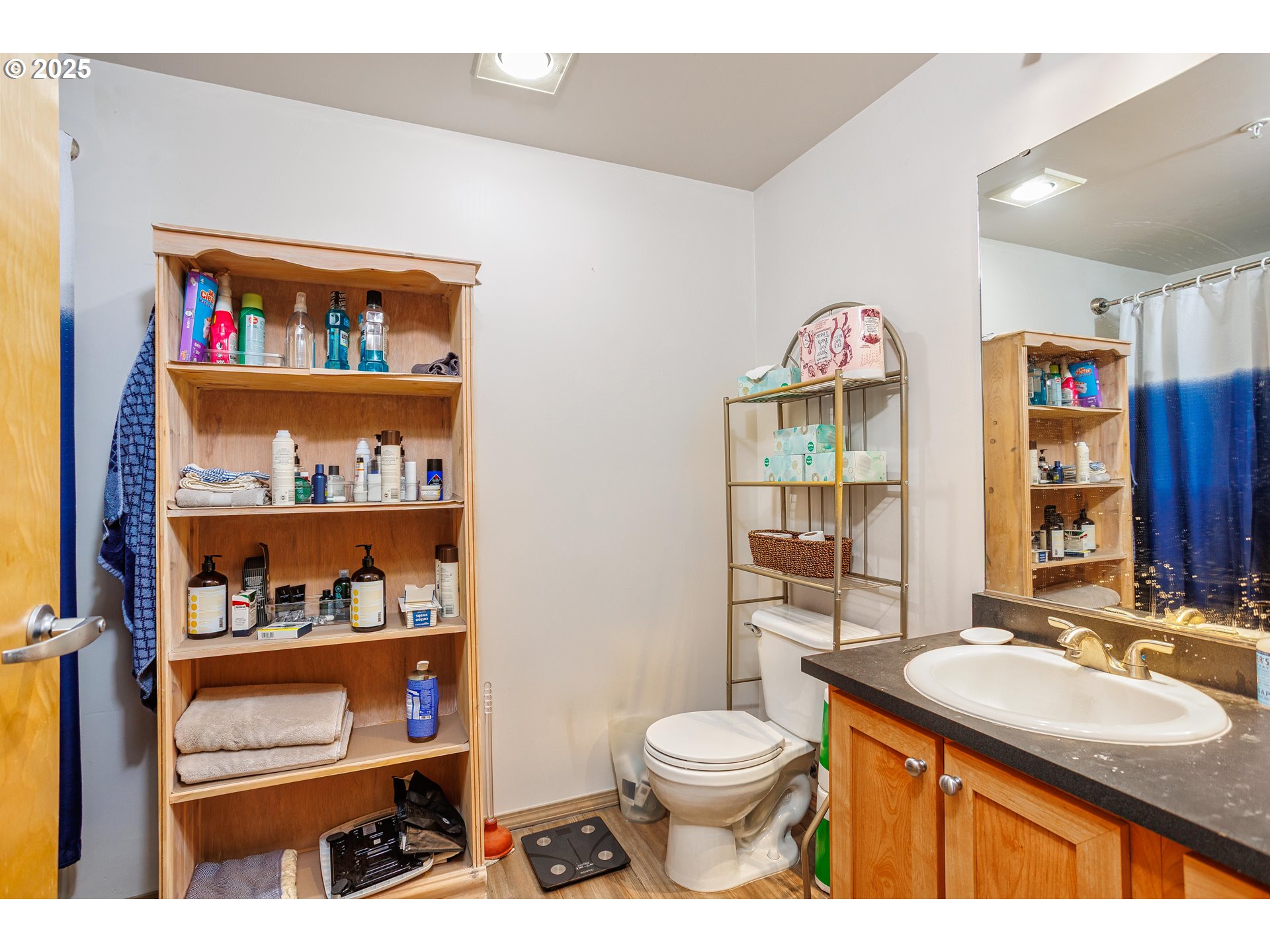 701 Columbia Street, Unit 702 Vancouver, WA 98660 - Photo 6 of 19 a bathroom with a sink a toilet and a large mirror