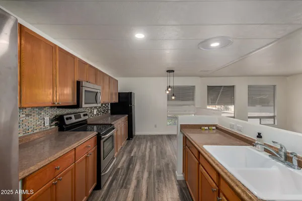 a kitchen with a sink stove and refrigerator