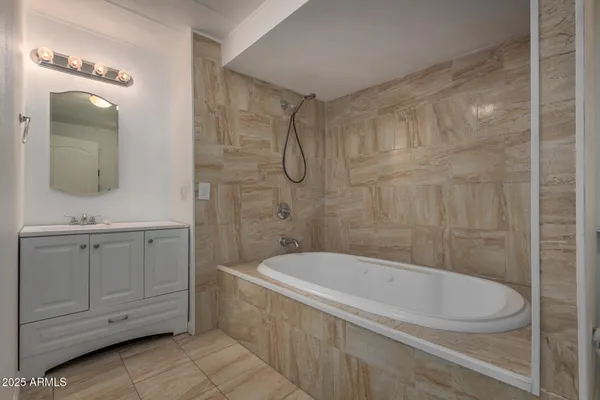 a white bath tub sitting in a bathroom and shower