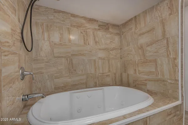 a bathroom with a bath tub with a shower
