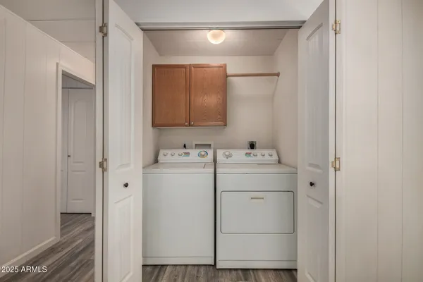 a utility room with cabinets washer and dryer