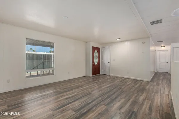wooden floor in an empty room with a window