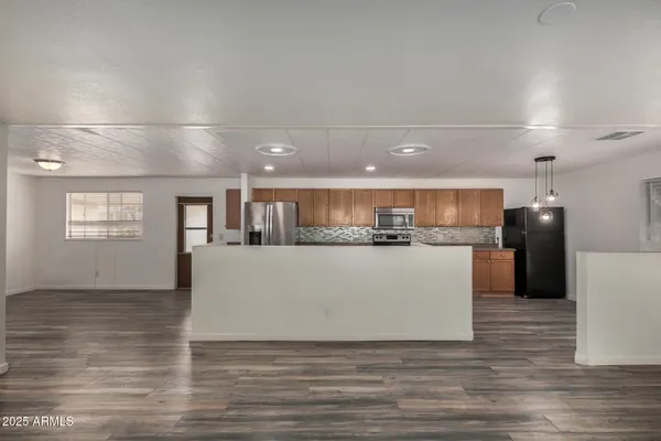a view of kitchen with refrigerator and microwave