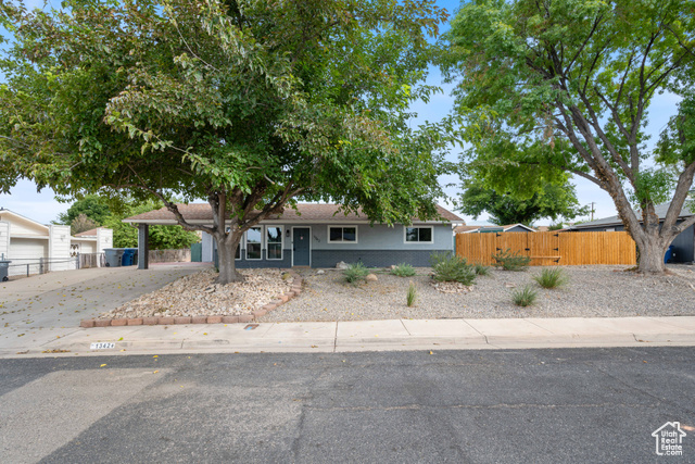 View of front of property with a carport and driveway
