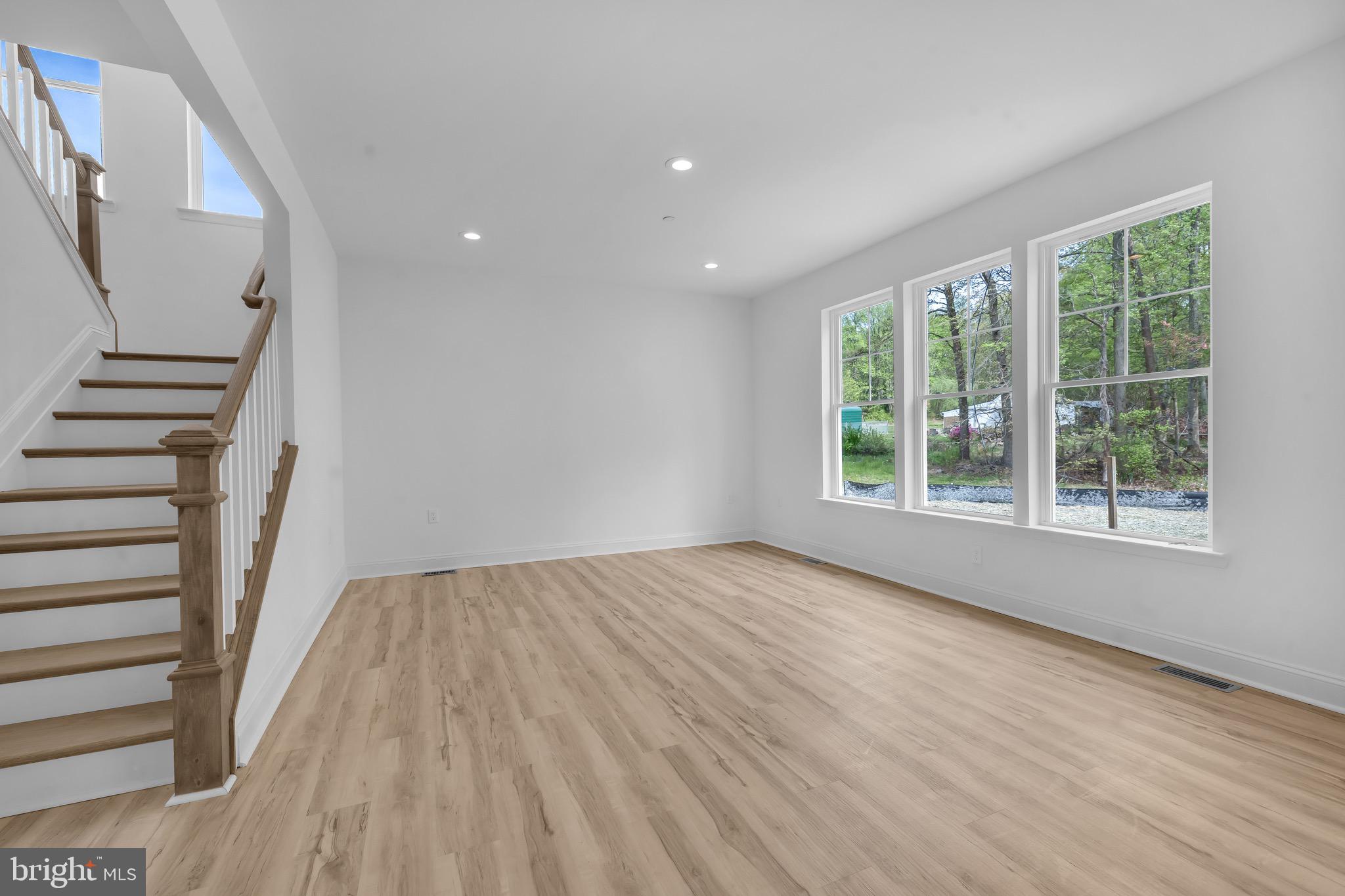 415 Trimble Road Joppa, MD 21085 - Photo 13 of 14 a view of an empty room with wooden floor and a window