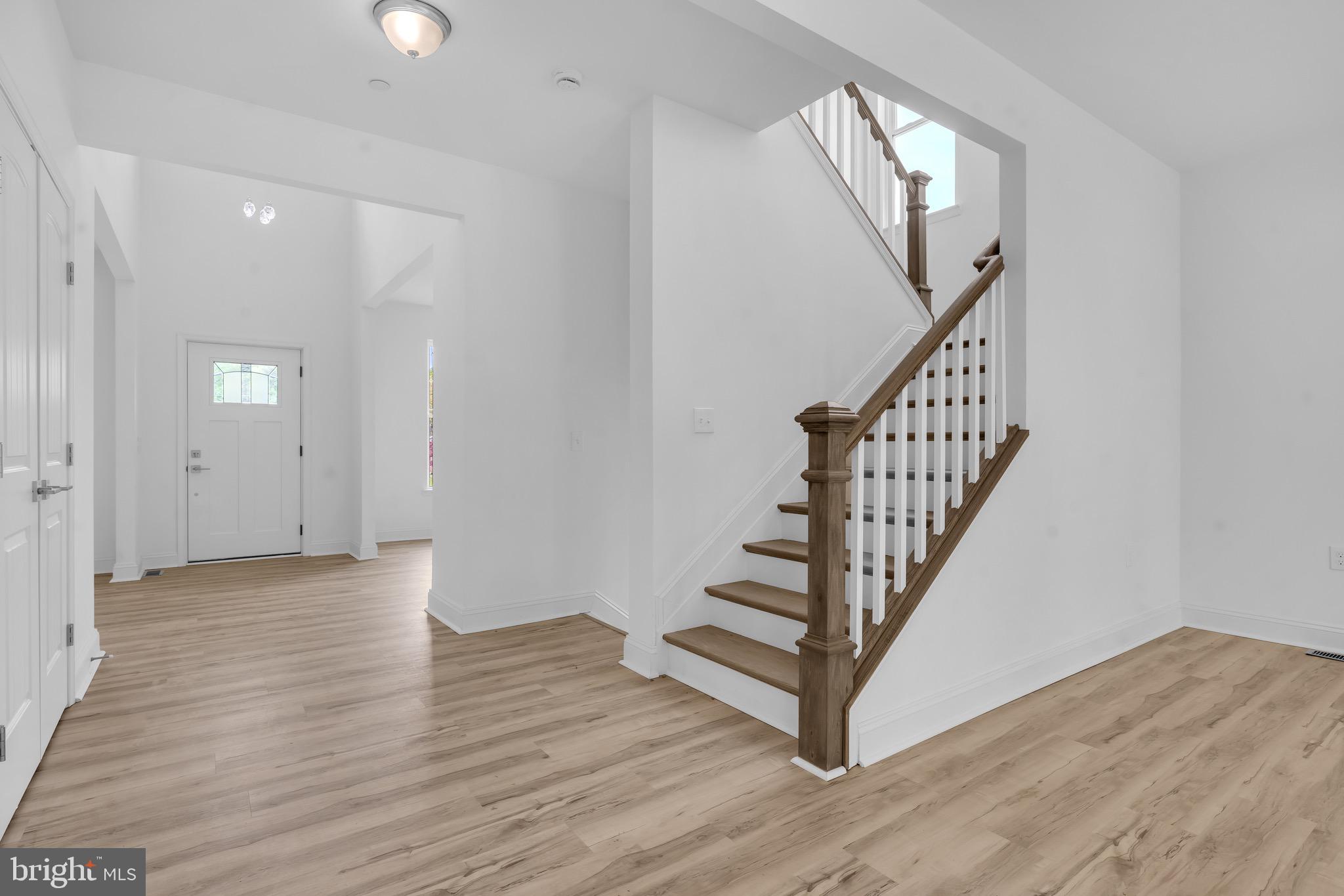 415 Trimble Road Joppa, MD 21085 - Photo 7 of 14 an empty room with wooden floor and windows