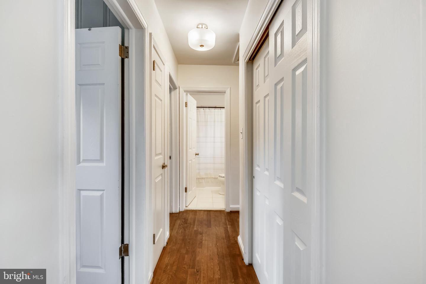 10310 Brunswick Avenue Silver Spring, MD 20902 - Photo 2 of 4 a view of a hallway with wooden floor and staircase