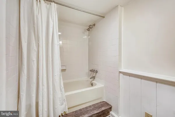 a bathroom with a bathtub and shower