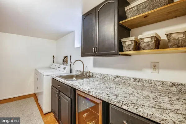 a kitchen with granite countertop sink and cabinets