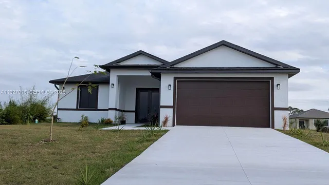 a front view of a house with a yard and garage