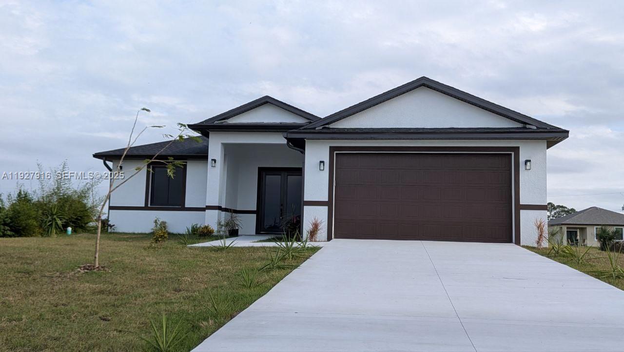 a front view of a house with a yard and garage
