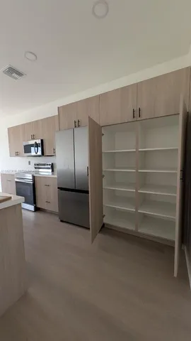 a kitchen with cabinets and stainless steel appliances