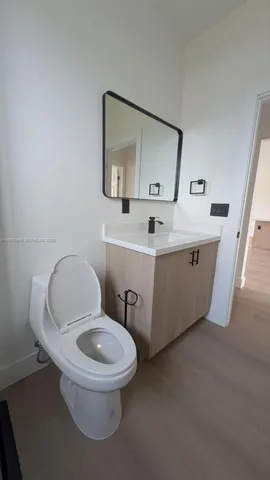 a white toilet sitting next to a bathroom sink