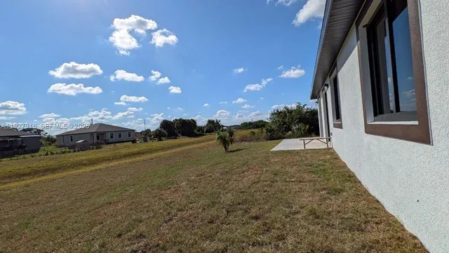 a view of a house with a backyard