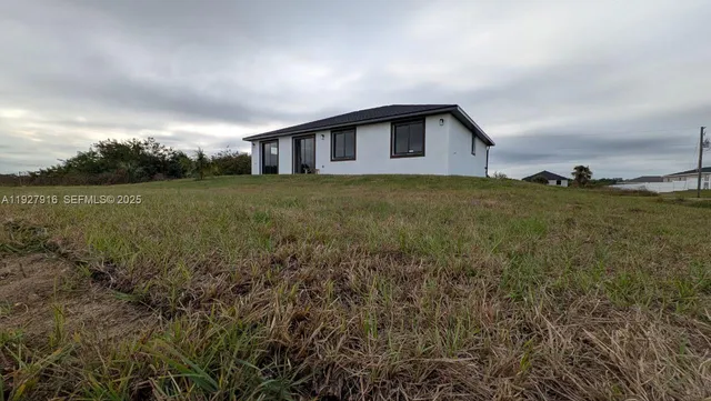 a backyard of a house with large trees