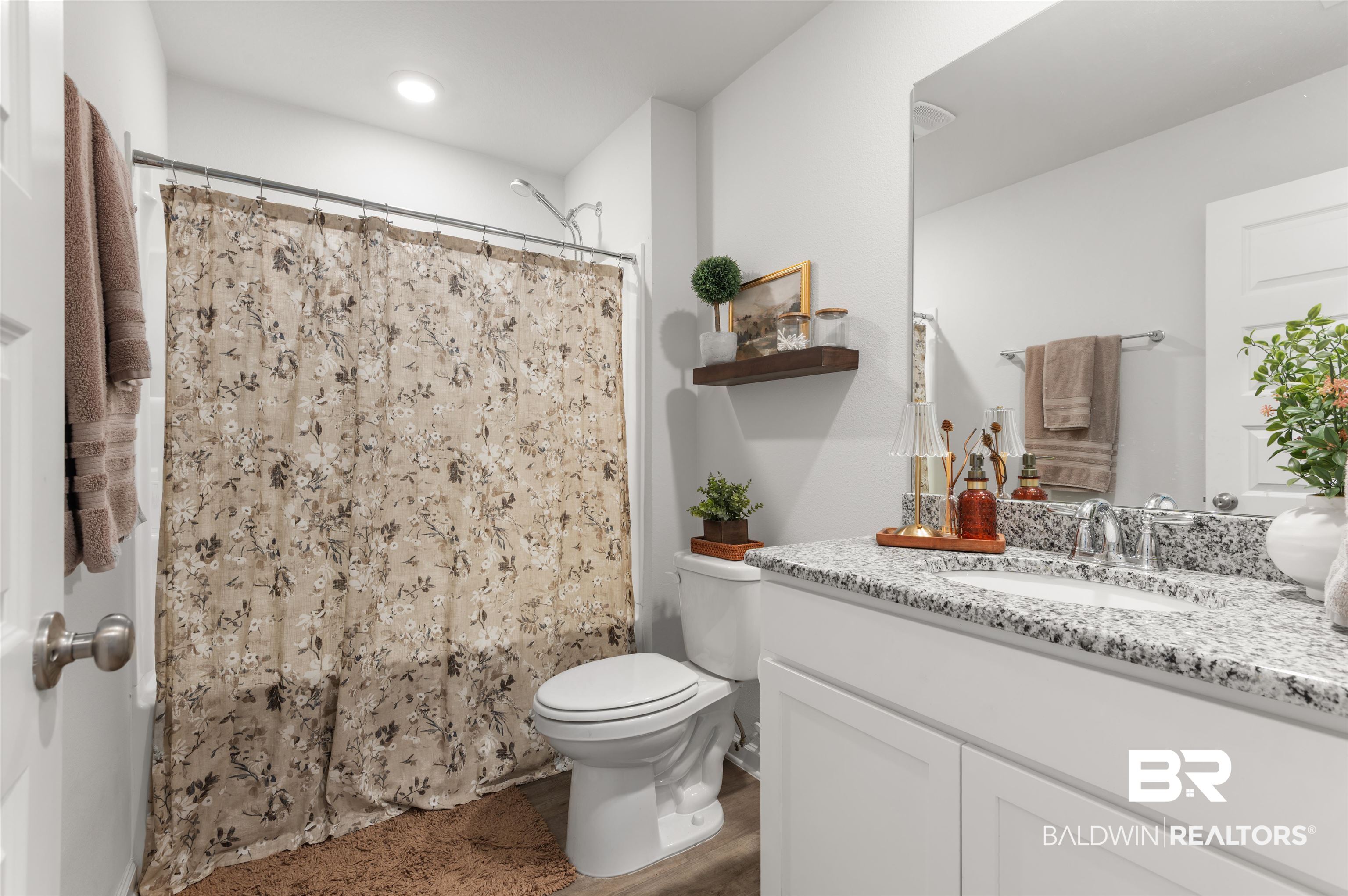 23544 Unbridled Loop Daphne, AL 36526 - Photo 19 of 25 Bathroom featuring a shower-tub combination, single-sink vanity with a stone countertop, and a white cabinet base