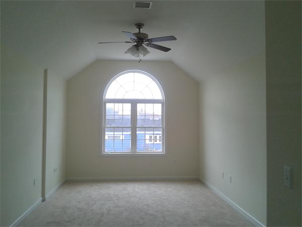 365 Abbott Street Springfield, MA 01118 - Photo 14 of 27 an empty room with a chandelier fan and windows