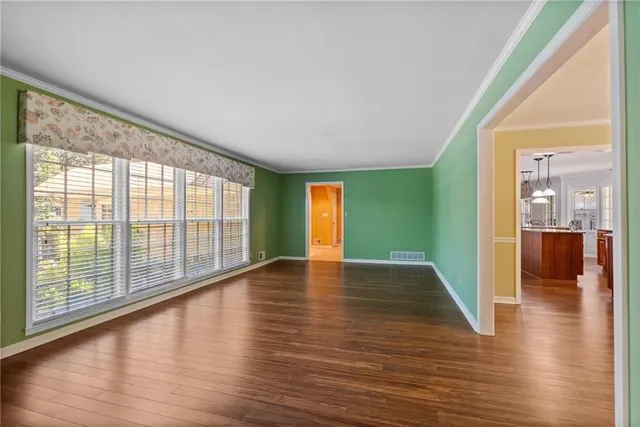 a view of room with window and wooden floor