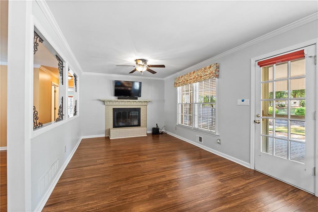 240 Deerfield Road Bogart, GA 30622 - Photo 18 of 80 a view of a livingroom with wooden floor a fireplace and windows