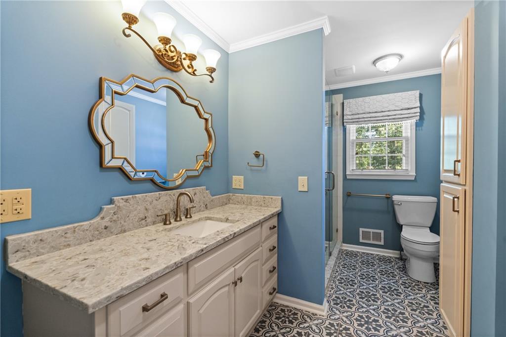 240 Deerfield Road Bogart, GA 30622 - Photo 27 of 80 a bathroom with a sink a toilet and a mirror