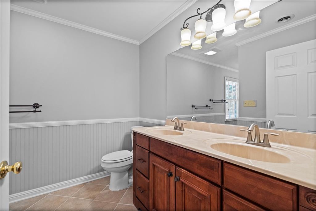 240 Deerfield Road Bogart, GA 30622 - Photo 43 of 80 a bathroom with a sink a toilet and a mirror