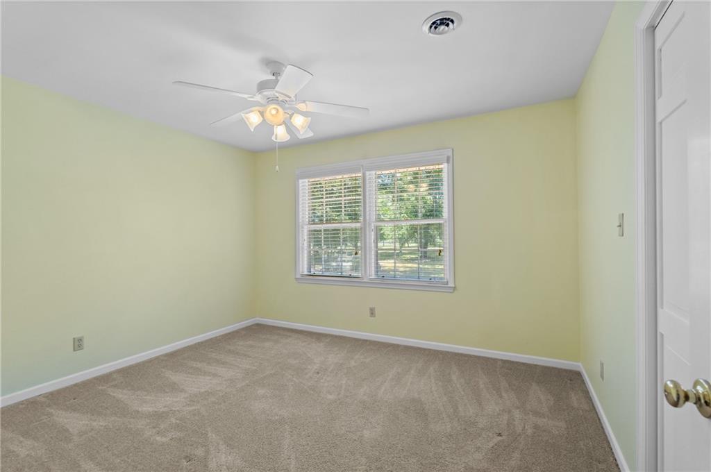 240 Deerfield Road Bogart, GA 30622 - Photo 46 of 80 an empty room with a window and a ceiling fan