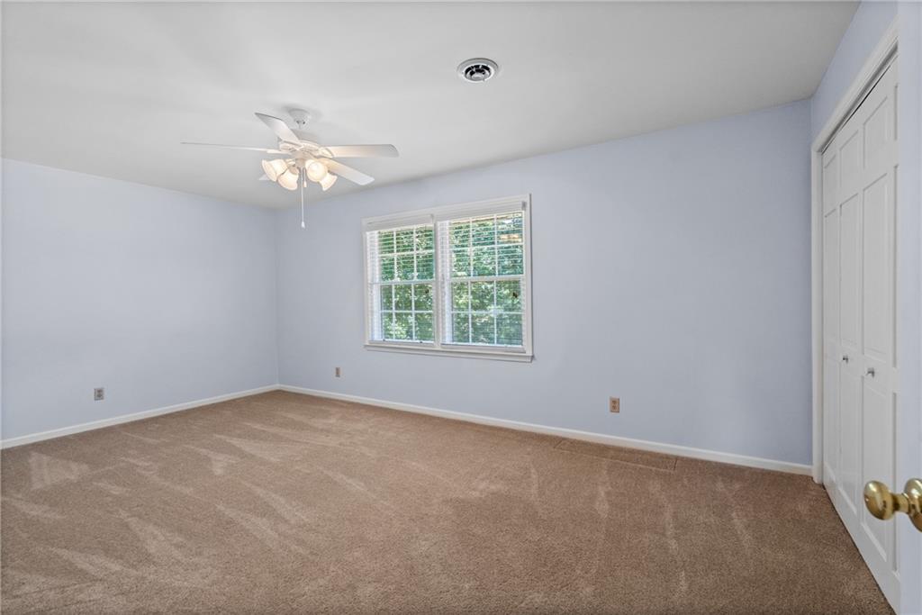 240 Deerfield Road Bogart, GA 30622 - Photo 49 of 80 an empty room with a window and ceiling fan
