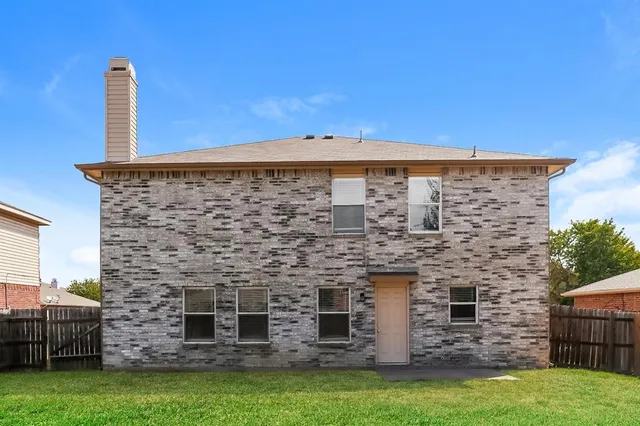a brick building with a yard