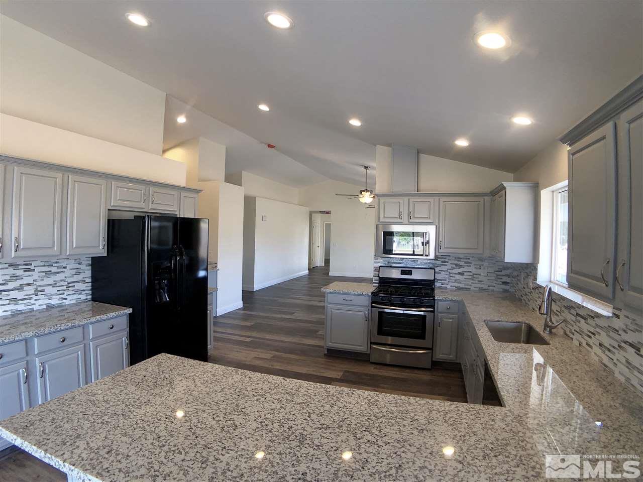 10205 Placerville Road Reno, NV 89508 - Photo 11 of 40 a kitchen with refrigerator and cabinets