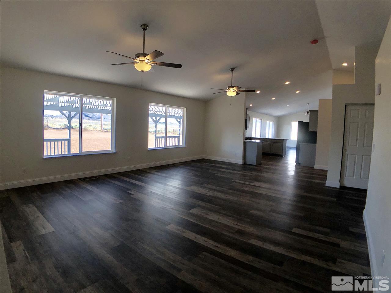 10205 Placerville Road Reno, NV 89508 - Photo 13 of 40 an empty room with wooden floor and windows