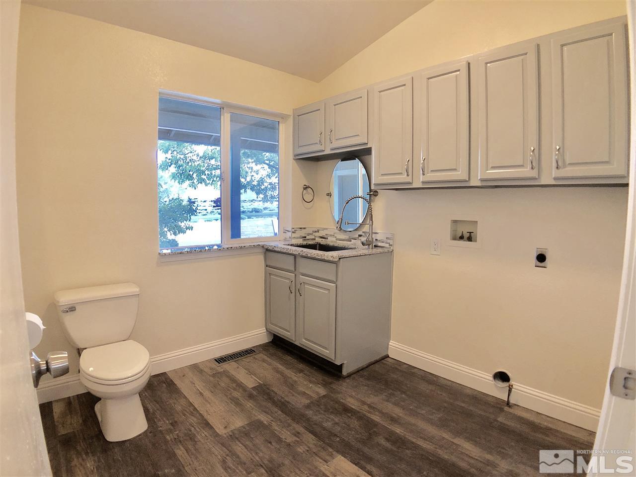 10205 Placerville Road Reno, NV 89508 - Photo 17 of 40 a view of a kitchen with wooden floor and a sink
