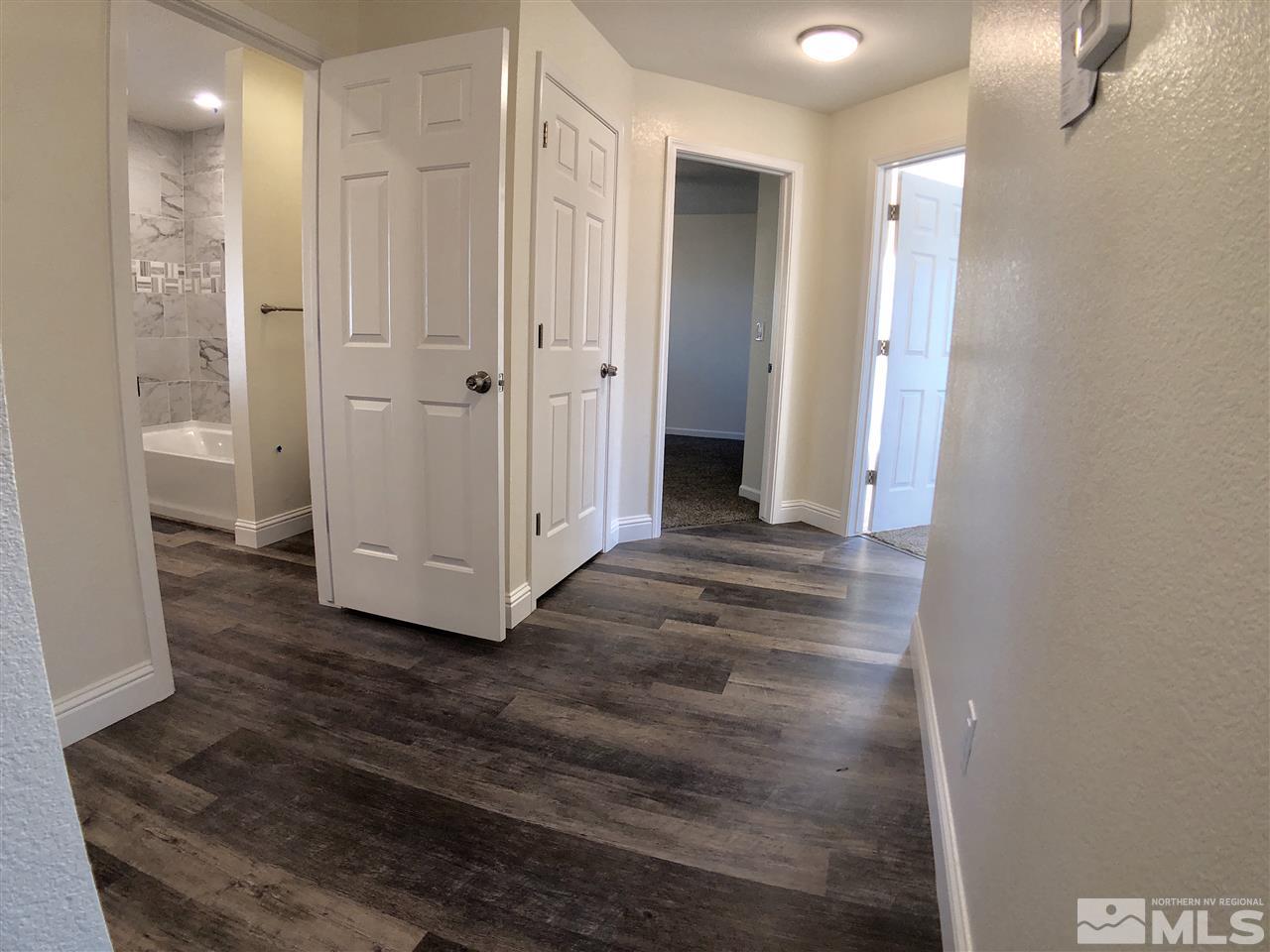 10205 Placerville Road Reno, NV 89508 - Photo 18 of 40 a view of a hallway with wooden floor and closet area