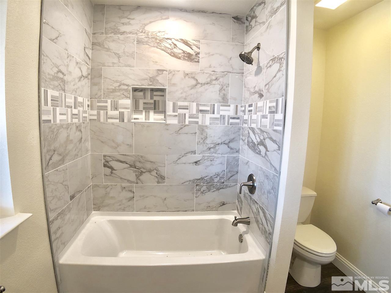 10205 Placerville Road Reno, NV 89508 - Photo 21 of 40 a white bath tub sitting next to a white toilet