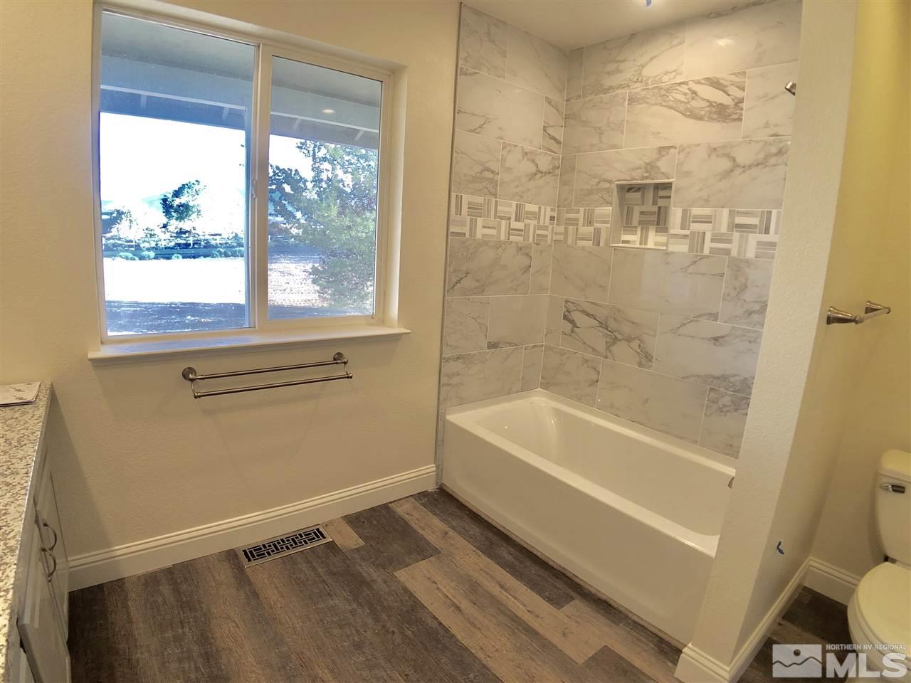 10205 Placerville Road Reno, NV 89508 - Photo 22 of 40 a bathroom with a bathtub and a shower