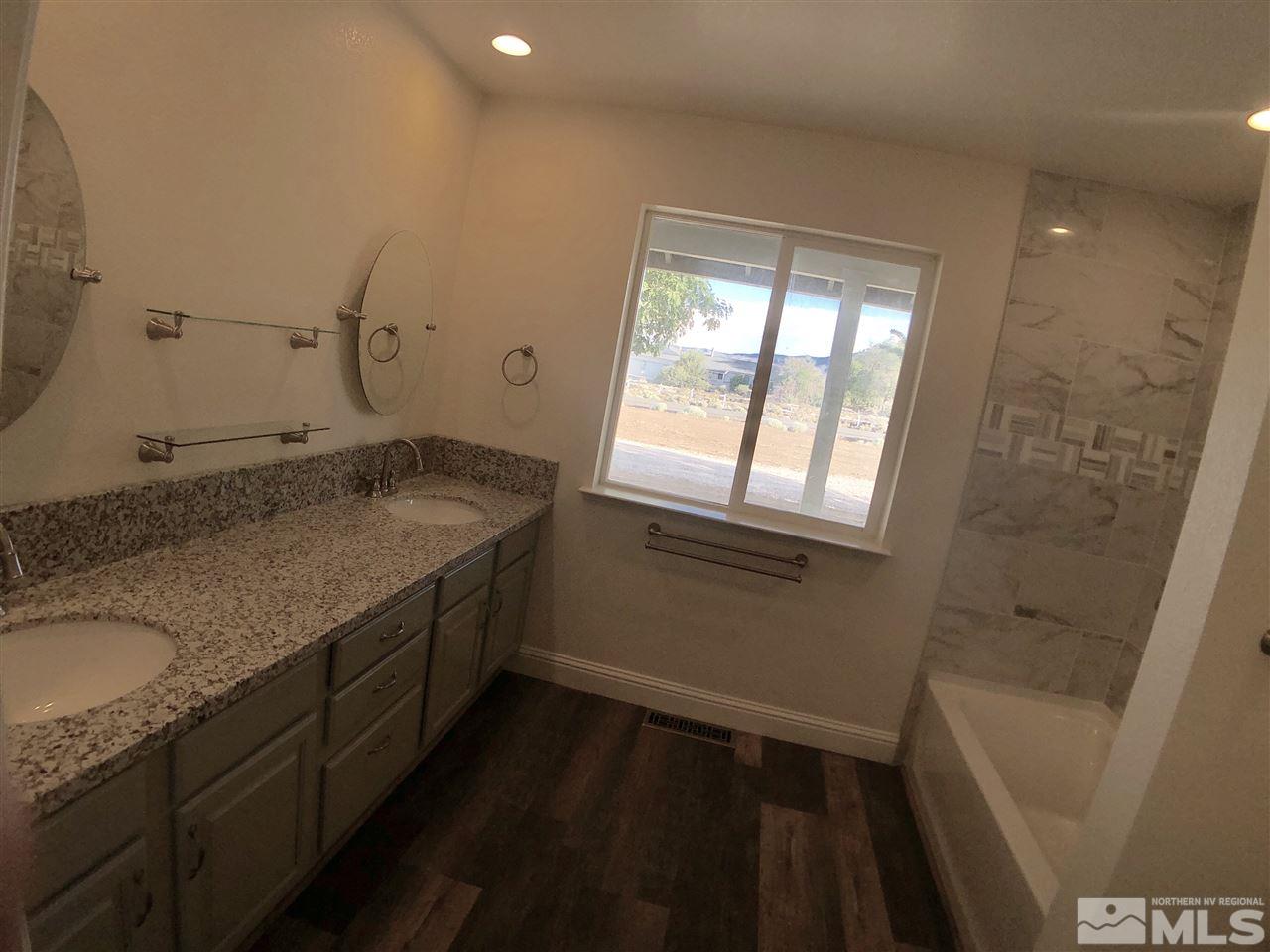 10205 Placerville Road Reno, NV 89508 - Photo 24 of 40 a bathroom with a granite countertop sink toilet and shower
