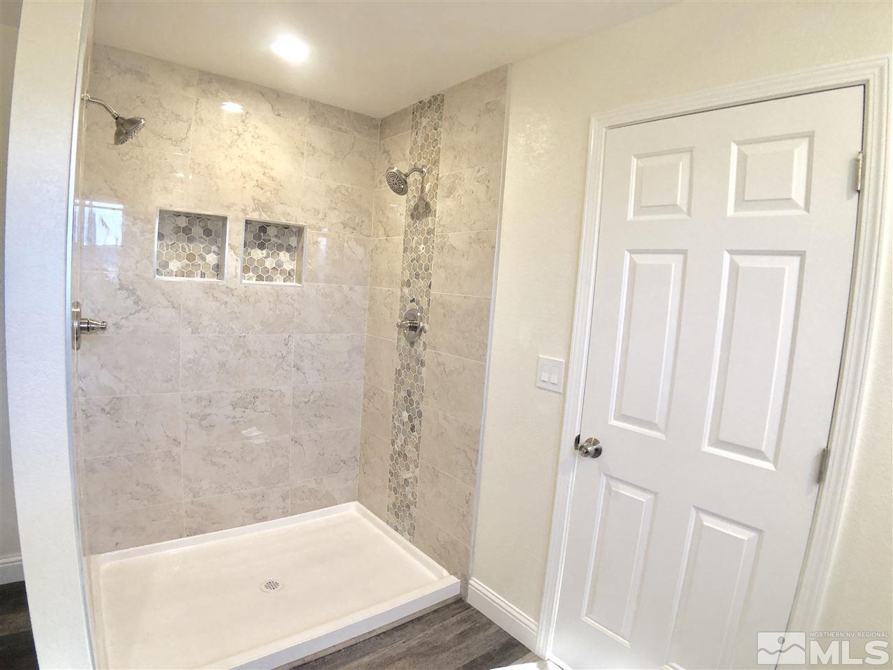 10205 Placerville Road Reno, NV 89508 - Photo 30 of 40 a bathroom with a tub and shower